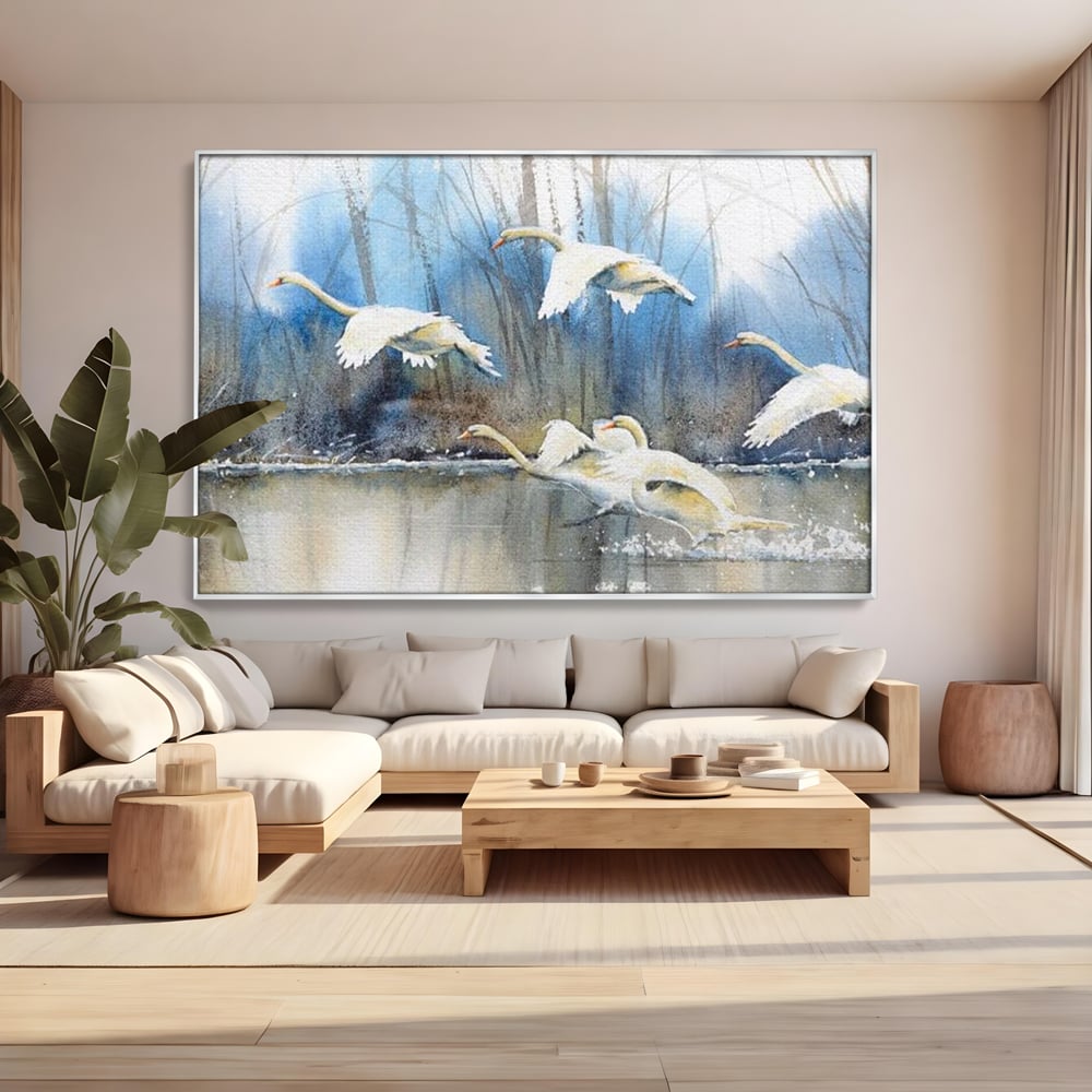 Tablou canvas cu pictura cu lebede pe apa, in rama de aluminiu argintiu, pe perete intr-un living